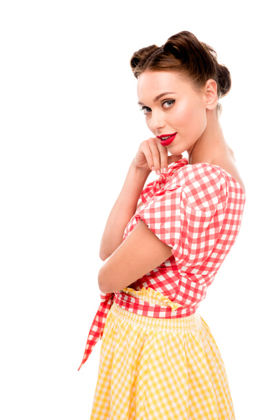 Stylish pin up girl holding hand on cheek and looking at camera isolated on white - Foto, Imagem