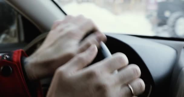 Man Driving a Car at winter. Male Hand on steering wheel close up. - Video, Çekim
