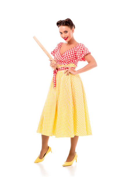 Smiling stylish pin up girl holding rolling pin and looking at camera isolated on white - Φωτογραφία, εικόνα
