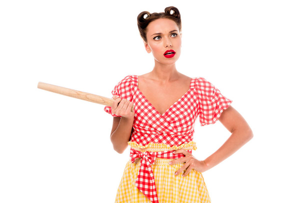 Young pretty pin up girl holding rolling pin isolated on white - 写真・画像