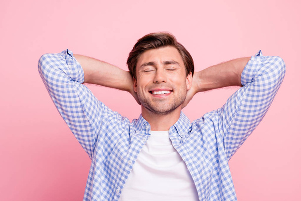 Close up photo of beautiful amazing brunet he him his handsome arms behind head eyes closed toothy smiles day off wearing casual checkered plaid shirt outfit isolated on rose background - Fotografie, Obrázek