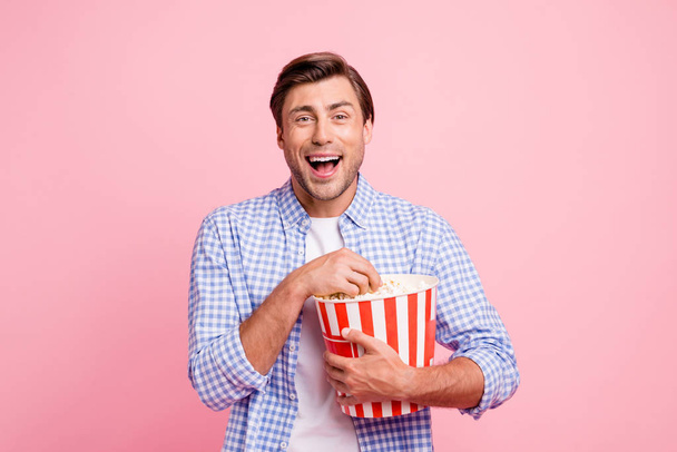 Close up photo of beautiful amazing brunet he him his handsome holding pop corn laughing on favorite tv show wearing specs casual checkered plaid shirt outfit isolated on rose background - Φωτογραφία, εικόνα