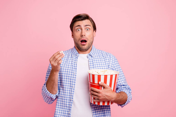 Close up photo of beautiful amazing brunet he him his handsome hold pop corn oh no facial expression watching scary movie wearing specs casual checkered plaid shirt outfit isolated on rose background - Foto, imagen