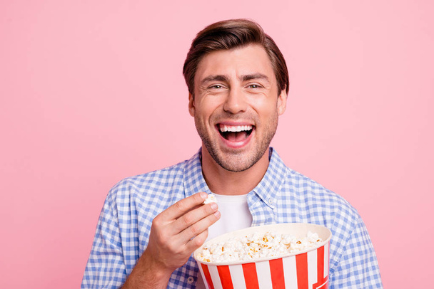 Close up photo of beautiful amazing brunet he him his handsome hold pop corn yelling of home alone movie funny moment wearing specs casual checkered plaid shirt outfit isolated on rose background - Фото, зображення
