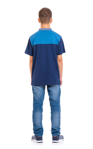 Full length portrait of young caucasian teen boy - rear view. Funny teenager - back view. Handsome child, isolated on white background. - Foto, afbeelding