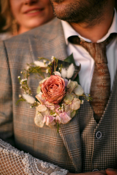 Wedding bouquet on the bride's jacket - Φωτογραφία, εικόνα