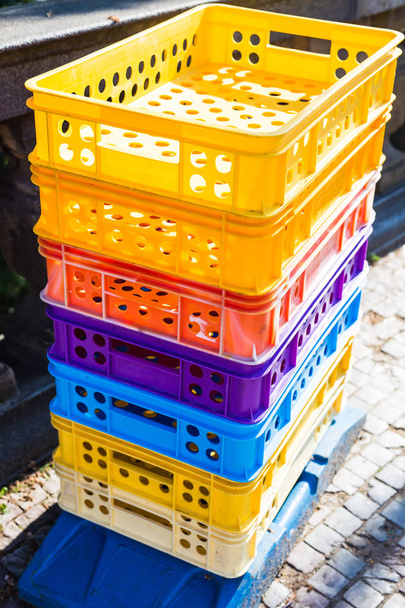 Colourful industrial plastic crates stuck up on top of each other - Photo, Image