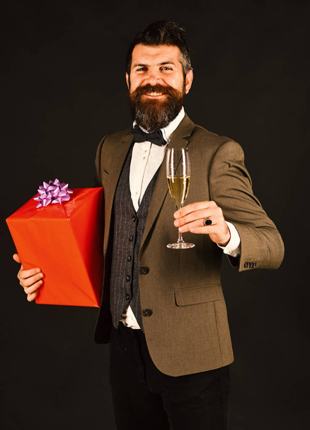 Businessman with happy face and red gift box. - Фото, изображение