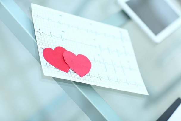 cardiogram and two red paper heart on the table - Photo, image