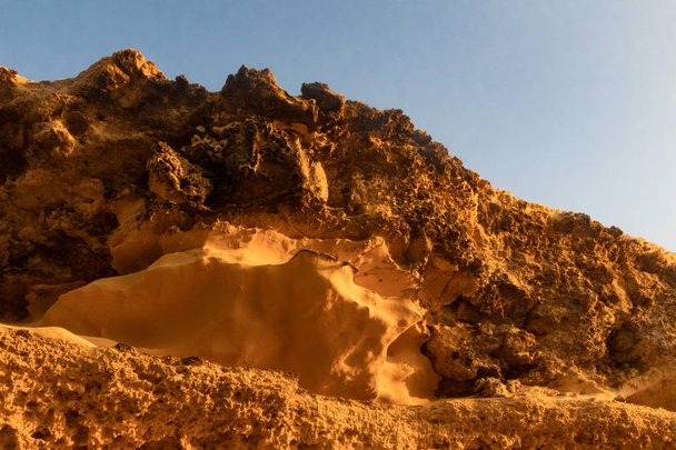 Cliff seen from below with the beautiful light of the sunset. - Photo, Image