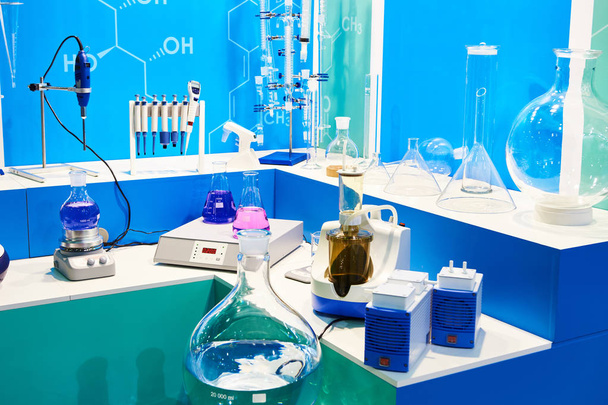 Chemical flasks with liquids and equipment in lab - Photo, image