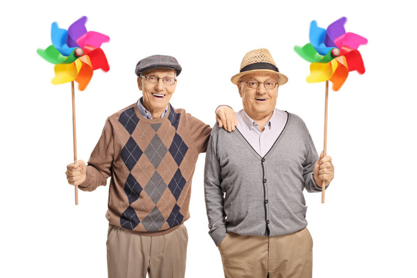 Happy senior men holding pinwheels isolated on white background - Foto, Imagem