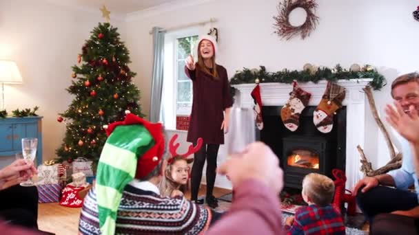 Multi-generation family playing charades as they gathering to celebrate Christmas at home together - shot in slow motion - Video