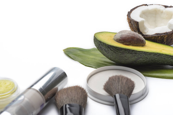 Natural herbal skin care products, top ingredients, coconut, avocado, isolated background makeup brushes for face. Preparation facial skin care. - Photo, Image
