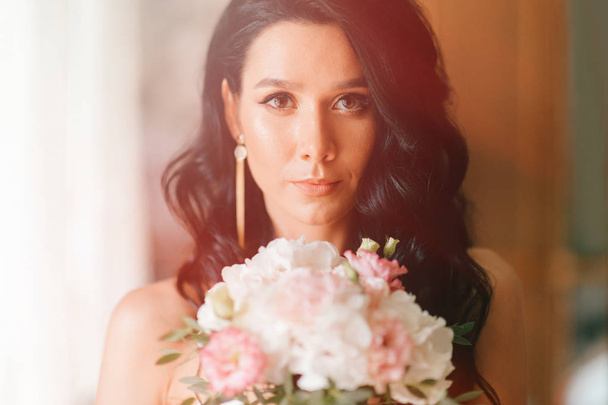 beautiful bride in white dress with bouquet of flowers  - Photo, image