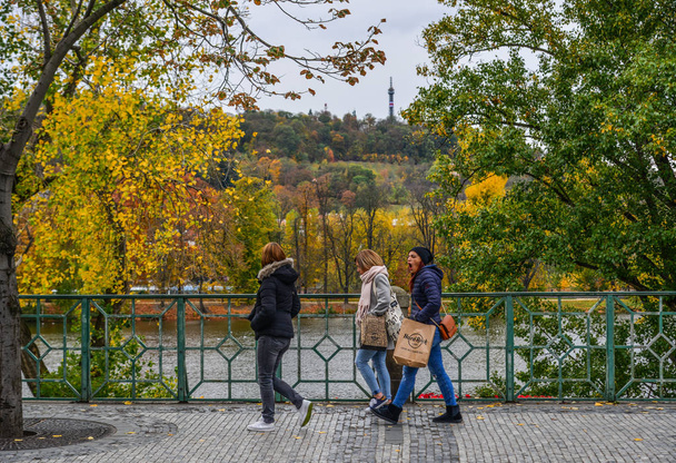 Prague, Czechia - Oct 26, 2018. People walking at autumn park in Prague, Czechia. Prague (Praha) is one of is the most beautiful cities in the world. - Photo, Image
