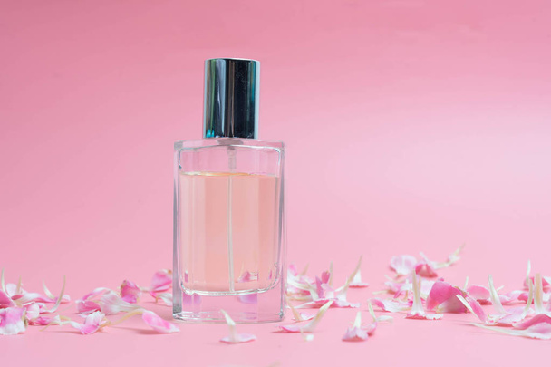 Beautiful perfume bottles  and rose on pink background - Foto, imagen