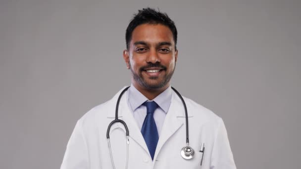 smiling indian male doctor with stethoscope - Video