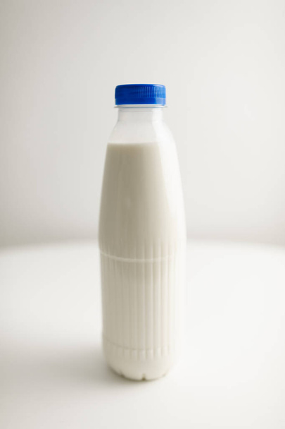 milk bottles on white table - Fotoğraf, Görsel