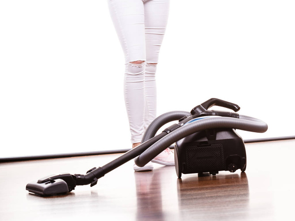 Household cleaning tools and devices, housekeeping duties concept. Woman legs and vacuum cleaner - Φωτογραφία, εικόνα