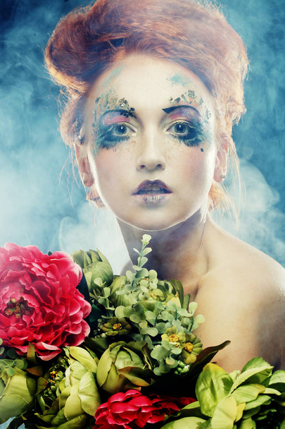 beautiful redhair woman  holding flowers - Фото, зображення