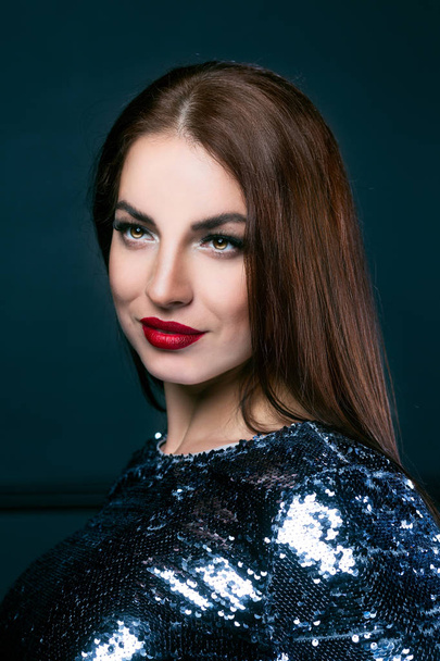 beautiful young brunette woman wearing a sparkling dress  - Valokuva, kuva