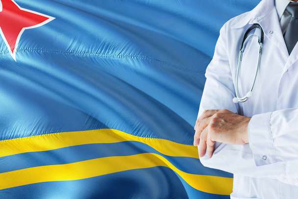 Doctor standing with stethoscope on Aruba flag background. National healthcare system concept, medical theme. - Foto, Bild