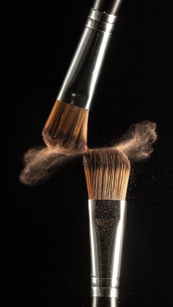 powder splash and brush for makeup artist or beauty blogger in black background - Zdjęcie, obraz