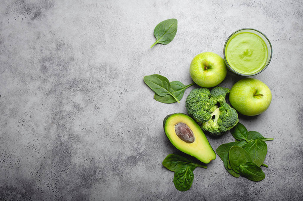 Ingredients for making green healthy smoothie with broccoli, apples, avocado, spinach, stone background. Clean eating, detox plan, diet, weight loss concept. Close up, top view, space for text - 写真・画像