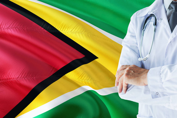 Guyanese Doctor standing with stethoscope on Guyana flag background. National healthcare system concept, medical theme. - Fotó, kép
