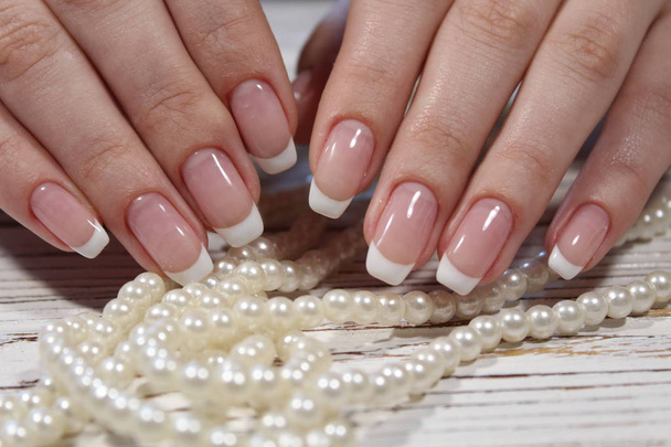 Beautiful French manicure on a trendy background - Photo, Image