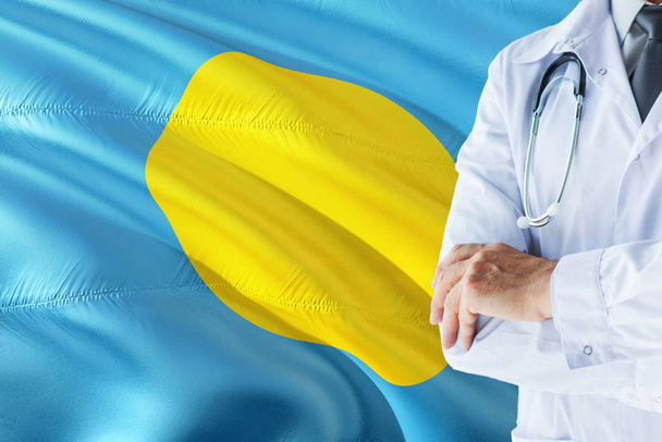Palauan Doctor standing with stethoscope on Palau flag background. National healthcare system concept, medical theme. - Фото, зображення