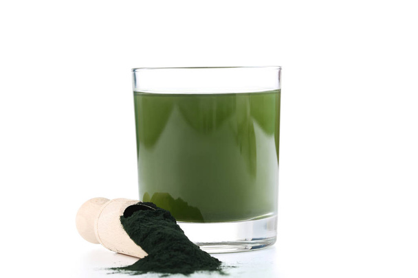 Spirulina drink and powder in scoop on white background - 写真・画像