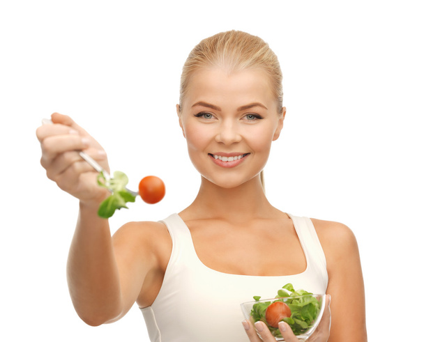Healthy woman holding bowl with salad - Photo, image