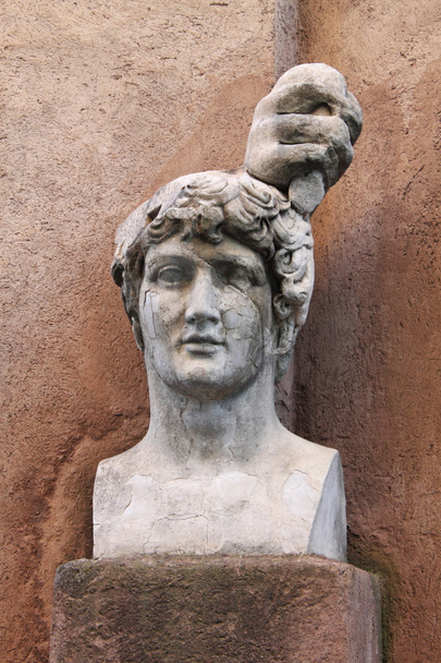 Marble roman bust against a wall in Rome, Italy - Photo, Image