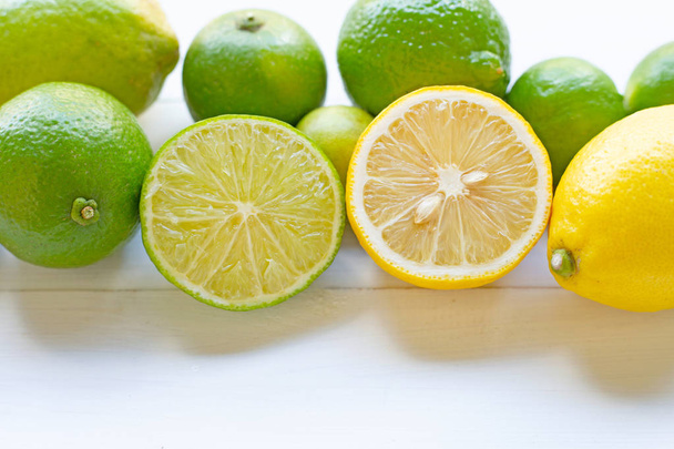 Ripe lemons and limes on white background. - Fotó, kép