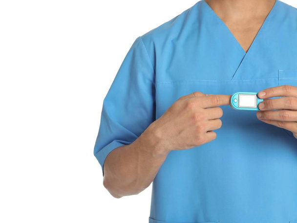 Male doctor using heart rate monitor on white background, closeup. Medical object - Valokuva, kuva