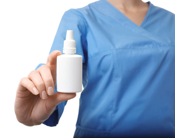 Female doctor holding plastic bottle with medicament on white background, closeup. Medical object - Foto, imagen