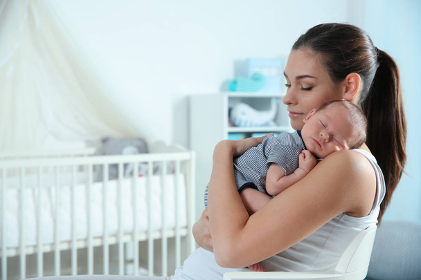 Young woman with her newborn baby on bed - Foto, Bild