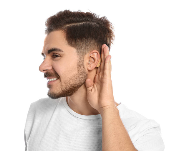 Young man with hearing aid on white background - Foto, Bild