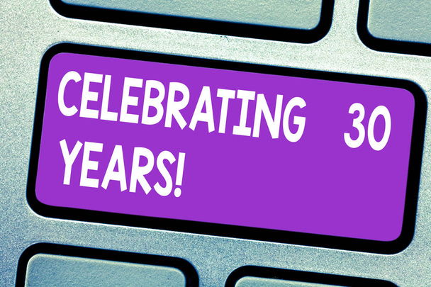 Text sign showing Celebrating 30 Years. Conceptual photo Commemorating a special day being 30 years together Keyboard key Intention to create computer message pressing keypad idea. - Photo, Image