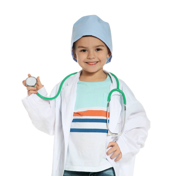 Cute little child in doctor coat with stethoscope on white background - Photo, Image