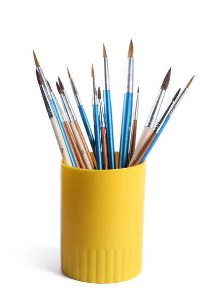 Holder with different paint brushes on white background - Fotografie, Obrázek