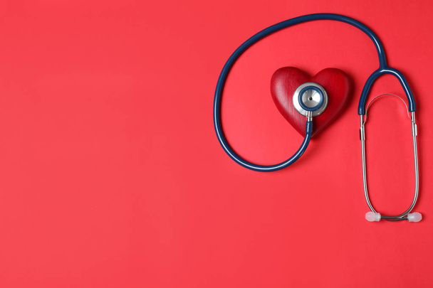 Stethoscope and red heart with space for text on color background, flat lay - Фото, изображение