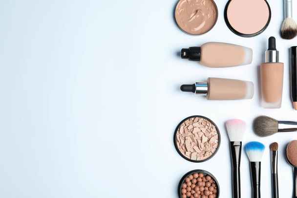 Flat lay composition with skin foundation, powder and beauty accessories on white background. Space for text - Foto, afbeelding
