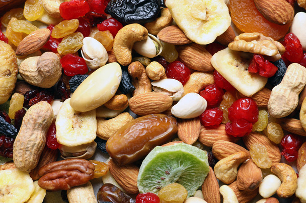 Different dried fruits and nuts as background, closeup - 写真・画像