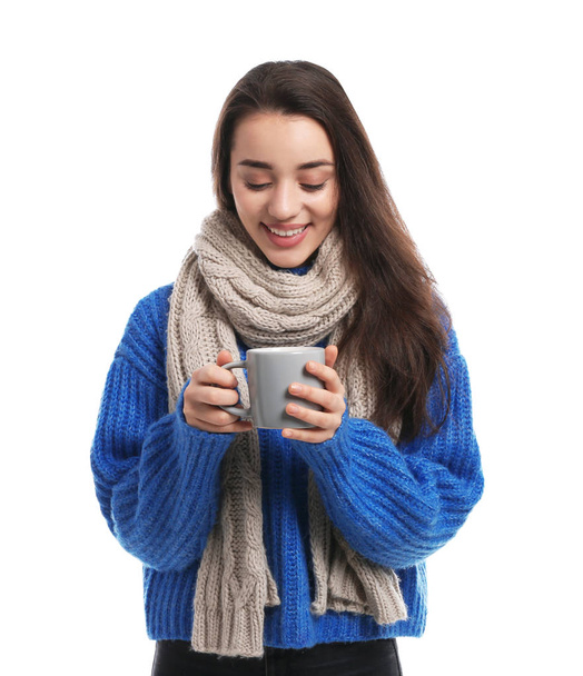 Young woman with cup of hot coffee on white background. Winter season - Fotoğraf, Görsel