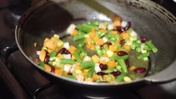 Housewife fries the vegetable mixture in a deep pan. Cooking healthy dinner at home. - Footage, Video