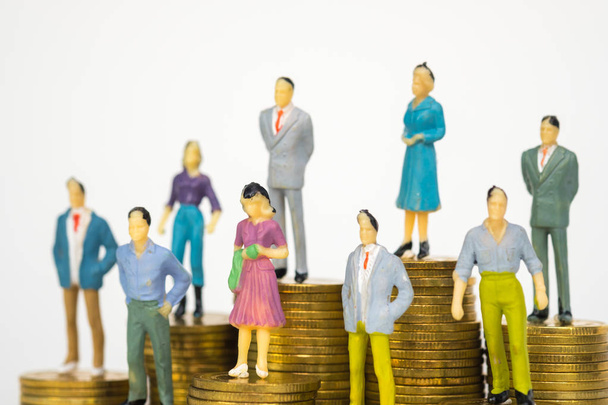 Figure miniature businessman or small people investor and office worker secretary standing on coin stack, for money and financial business success concept idea. - Fotoğraf, Görsel