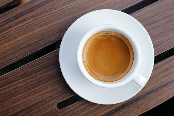 Espresso coffee hot in wooden background. - Foto, Bild